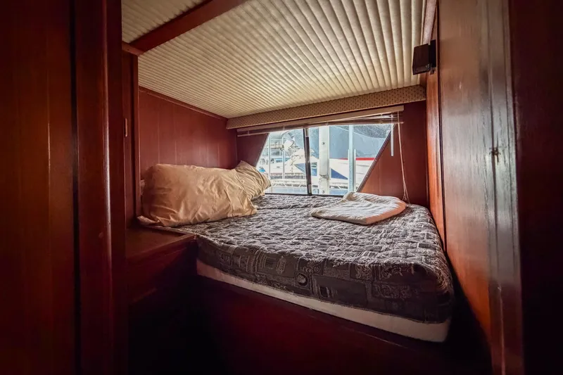 Slide: The Image of Cozy cabin interior of 1984 Blue Water 51 Coastal yacht with bed and window view. - 27