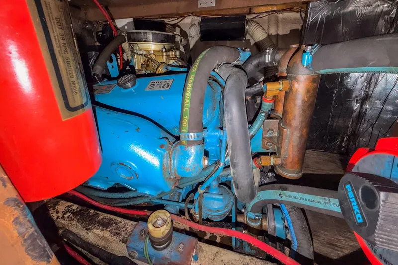 Slide: The Image of Engine compartment of a 1984 Blue Water 51 Coastal boat, featuring a blue engine. - 29