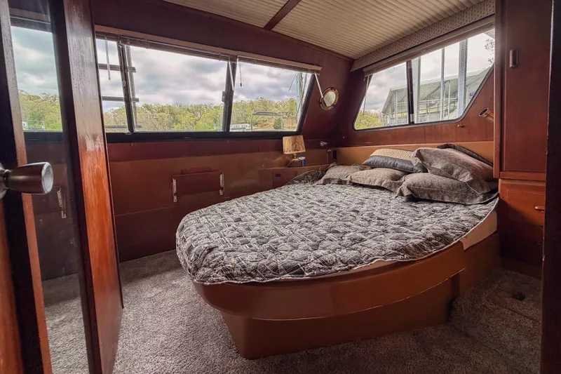Slide: The Image of Cozy bedroom interior of 1984 Blue Water 51 Coastal yacht with large windows and plush bedding. - 30