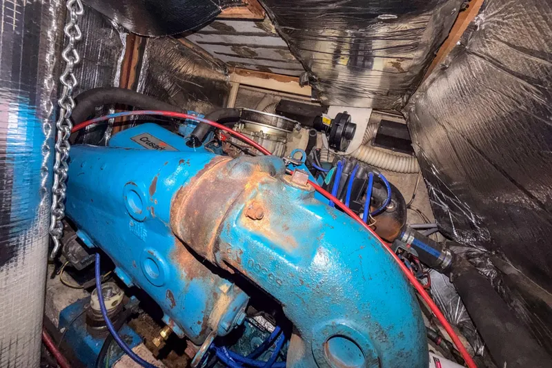 Slide: The Image of Engine compartment of a 1984 Blue Water 51 Coastal boat, featuring a Crusader engine. - 34