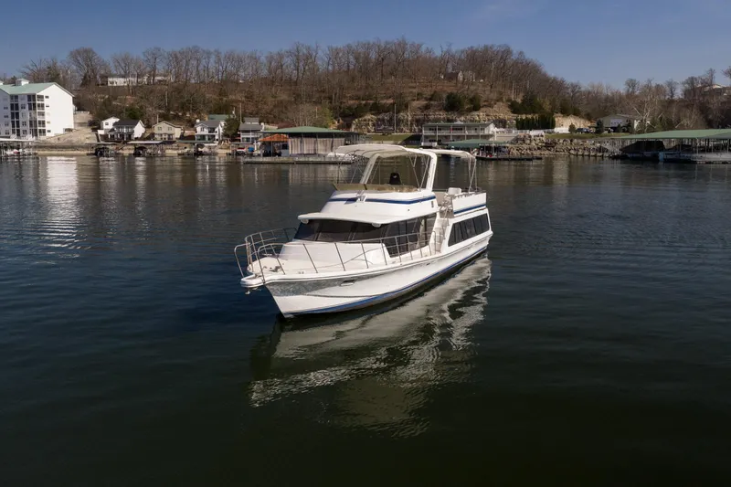 Slide: The Image of 1985 Blue Water 51 Coastal yacht on calm waters near a scenic shoreline. - 4