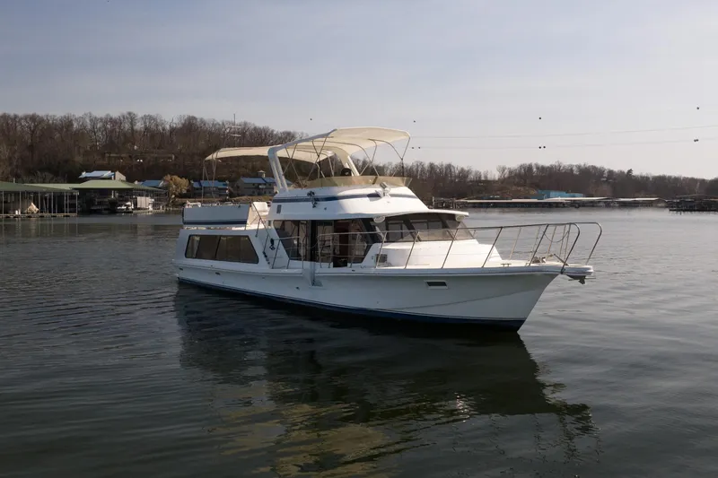 Slide: The Image of 1985 Blue Water 51 Coastal yacht on calm water near wooded shoreline. - 5