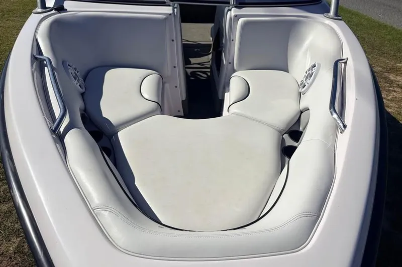 Slide: The Image of 2005 Nautique Super Air Nautique 210 boat interior with white cushioned seating. - 11