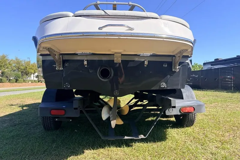 Slide: The Image of 2005 Nautique Super Air Nautique 210 boat on trailer, rear view, sunny day. - 13