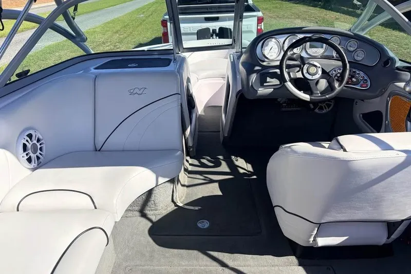 Slide: The Image of Interior of a 2005 Nautique Super Air Nautique 210 boat with steering wheel and seating. - 3