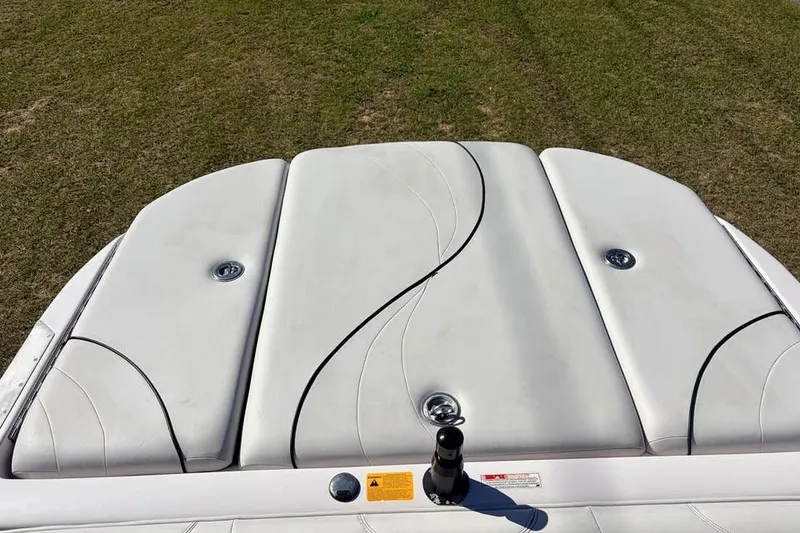 Slide: The Image of 2005 Nautique Super Air Nautique 210 boat interior with white cushioned seating. - 8