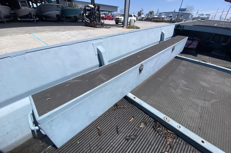 Slide: The Image of 2009 Pro-Drive X Series 17' boat interior with storage compartment, parked outdoors. - 13