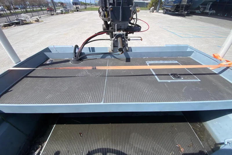 Slide: The Image of 2009 Pro-Drive X Series 17' boat deck with motor, parked outdoors. - 15