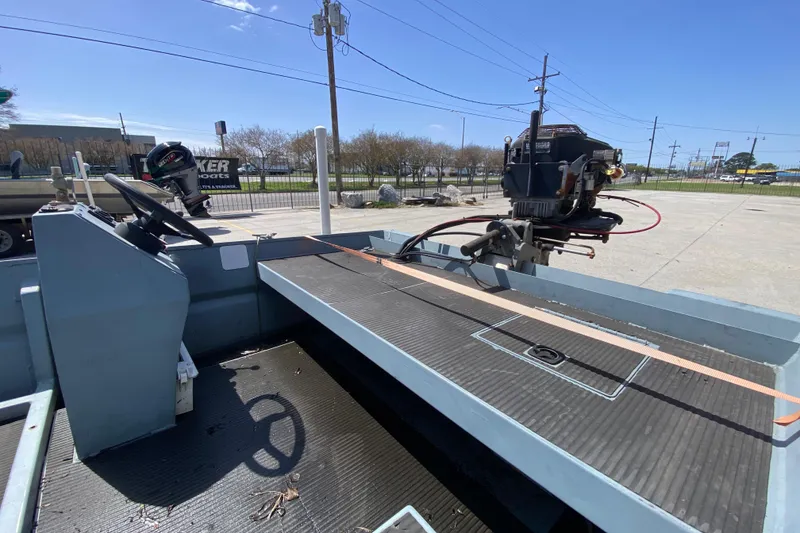 Slide: The Image of 2009 Pro-Drive X Series 17' boat with steering console and outboard motor in a parking lot. - 18