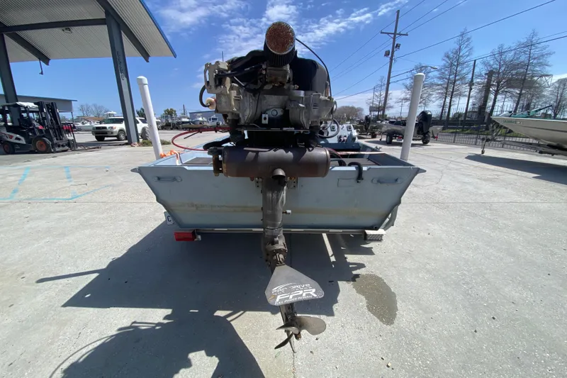 Slide: The Image of 2009 Pro-Drive X Series 17' boat with outboard motor in a marina setting. - 4