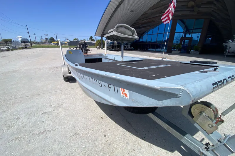 Slide: The Image of 2009 Pro-Drive X Series 17' boat on trailer, parked outdoors near a building. - 9