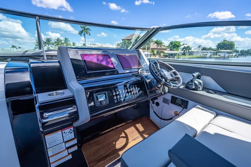 Slide: The Image of 2022 Cruisers Yachts 38 GLS OB helm with modern controls and dual screens. - 12