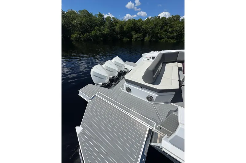 Slide: The Image of 2022 Cruisers Yachts 38 GLS OB with triple Mercury outboards on a serene lake. - 21