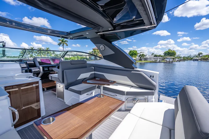 Slide: The Image of Luxurious 2022 Cruisers Yachts 38 GLS OB interior with sleek seating and scenic water view. - 22