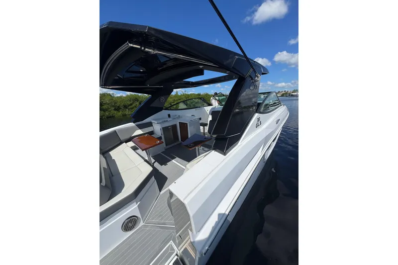 Slide: The Image of 2022 Cruisers Yachts 38 GLS OB on water, featuring sleek design and spacious seating. - 31