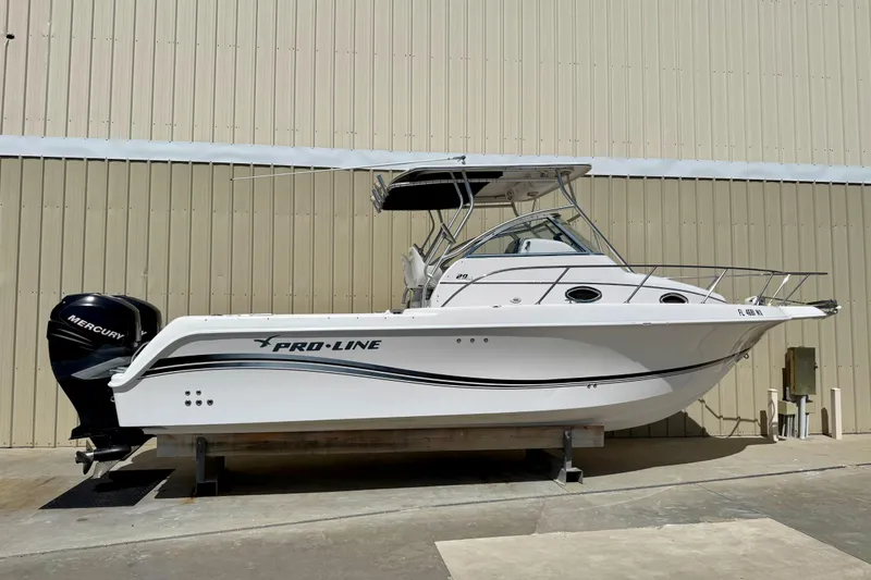 The Image of 2005 Pro-Line 29 Walkaround boat with Mercury engine, docked indoors. - 0