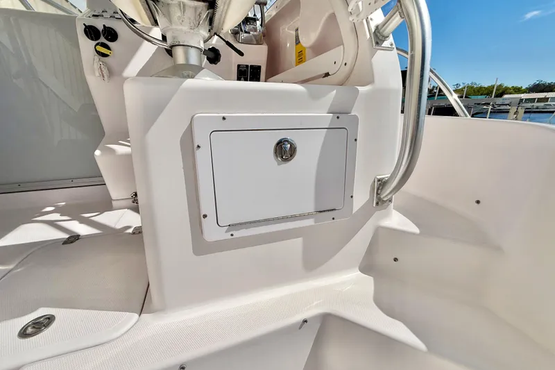 Slide: The Image of 2005 Pro-Line 29 Walkaround boat interior with storage compartment and control panel. - 14