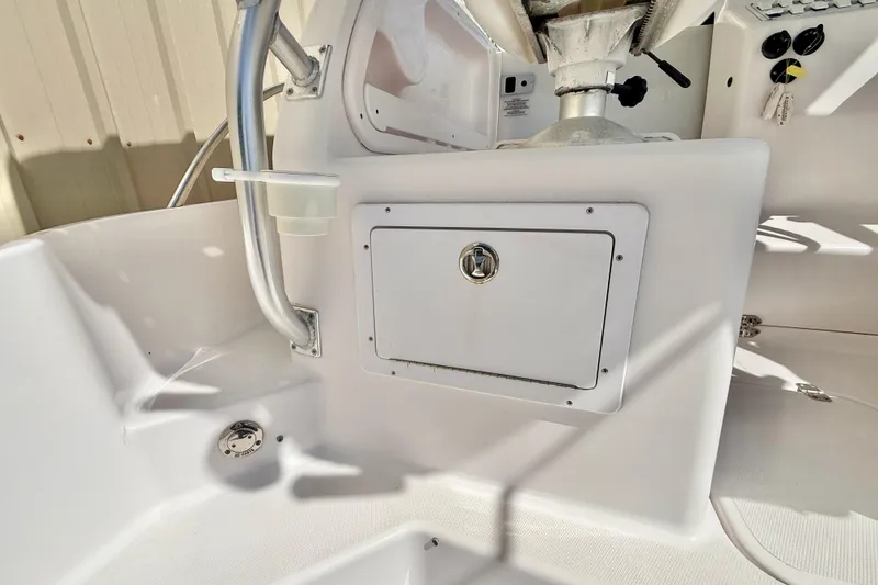 Slide: The Image of 2005 Pro-Line 29 Walkaround boat interior with storage compartment and control panel. - 16