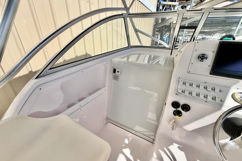 Slide: The Image of 2005 Pro-Line 29 Walkaround boat cockpit with control panel and seating area. - 17