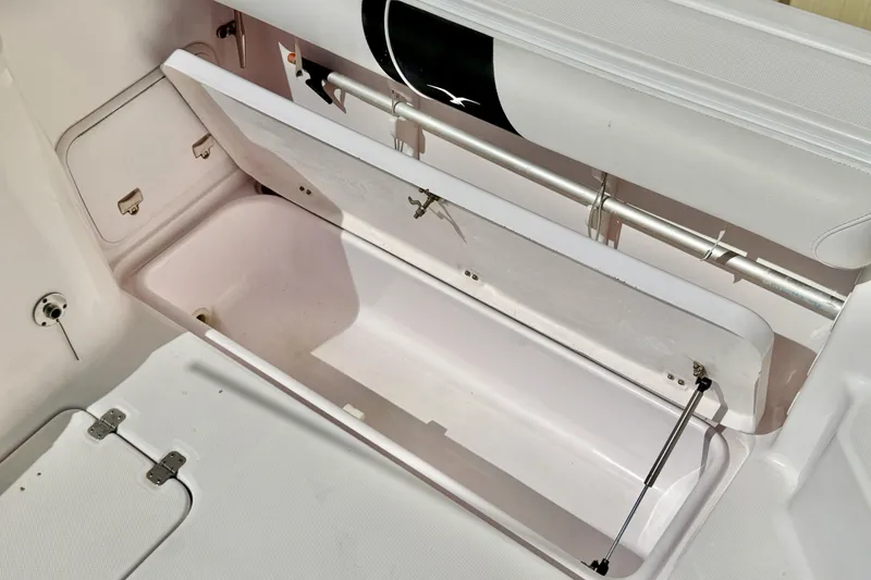 Slide: The Image of Open storage compartment on a 2005 Pro-Line 29 Walkaround boat, showcasing interior space. - 18