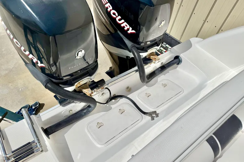 Slide: The Image of 2005 Pro-Line 29 Walkaround boat with dual Mercury outboard engines. - 20