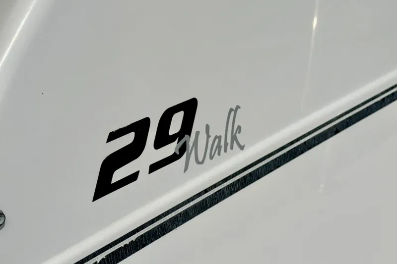 Slide: The Image of Pro-Line 29 Walkaround 2005 boat model name on white hull. - 23