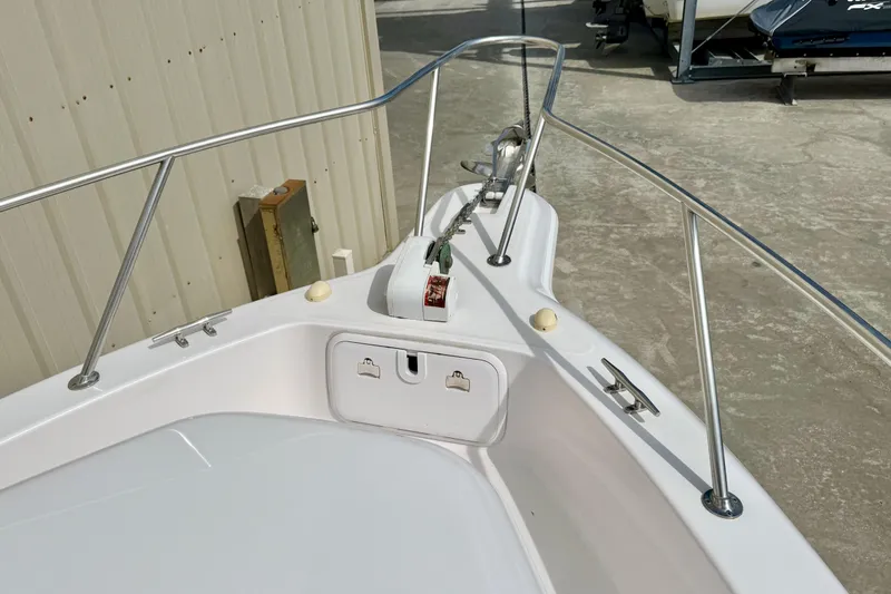 Slide: The Image of 2005 Pro-Line 29 Walkaround boat bow with anchor and railing. - 25