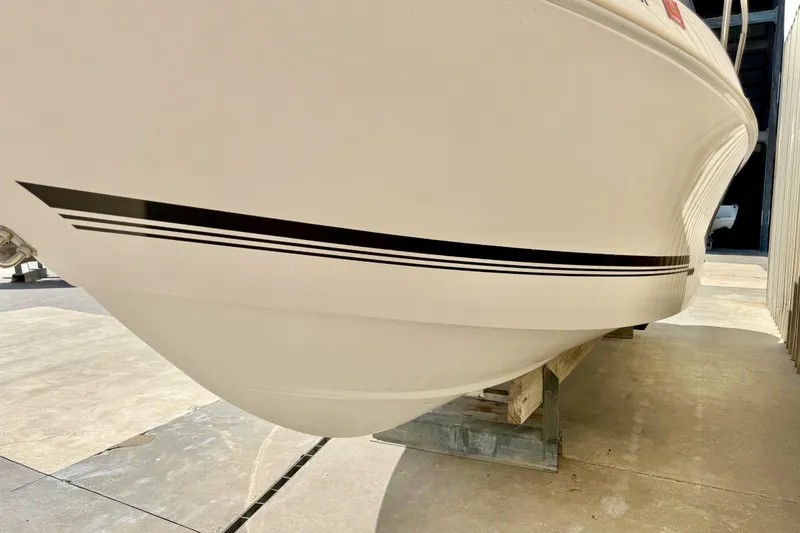 Slide: The Image of 2005 Pro-Line 29 Walkaround boat hull with sleek black stripe design. - 3