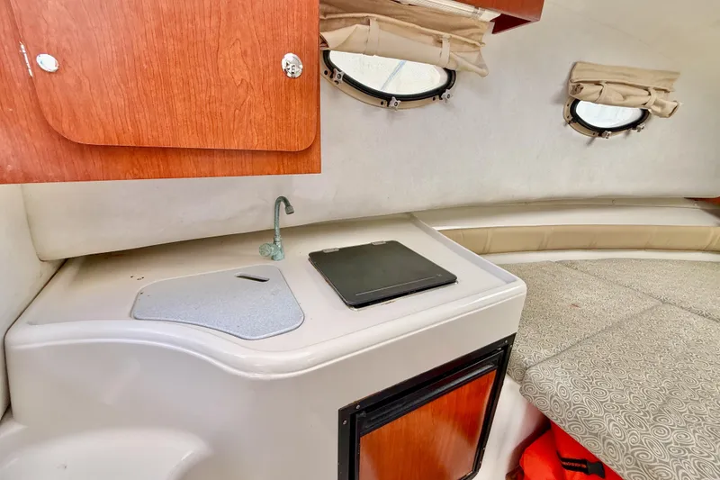 Slide: The Image of 2005 Pro-Line 29 Walkaround cabin interior with kitchenette and seating area. - 30