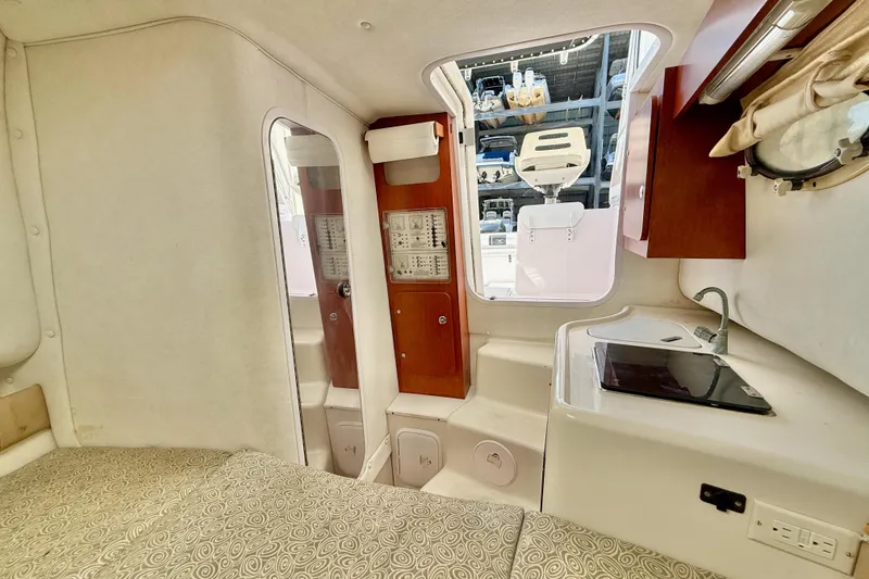 Slide: The Image of Interior of 2005 Pro-Line 29 Walkaround boat with kitchenette and seating area. - 37
