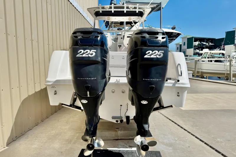 Slide: The Image of 2005 Pro-Line 29 Walkaround with twin 225 horsepower outboard engines at a marina. - 5