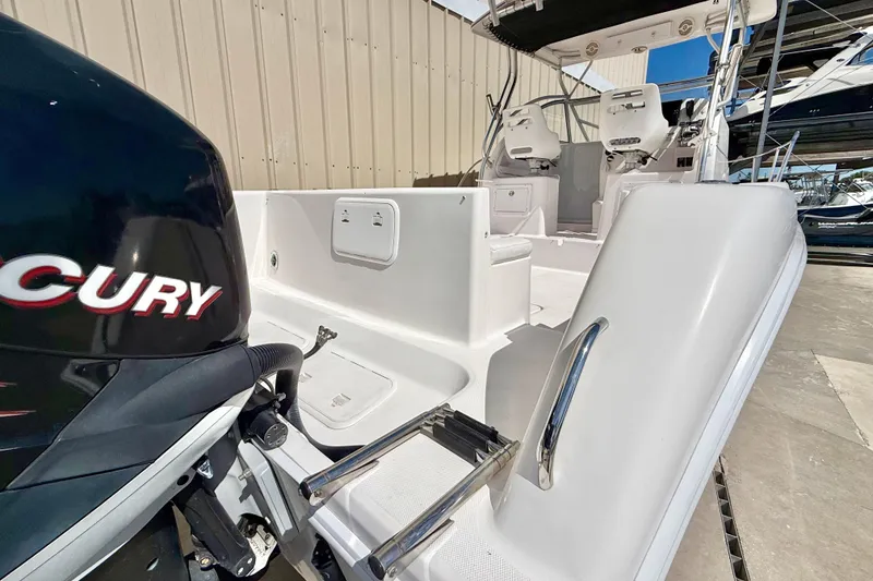 Slide: The Image of 2005 Pro-Line 29 Walkaround boat with Mercury engine, featuring spacious seating and modern design. - 6