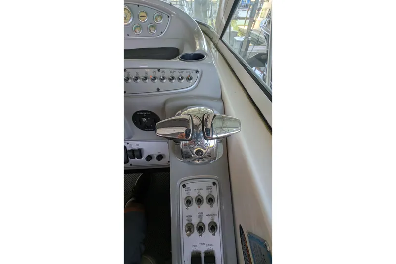 Slide: The Image of Control panel of a 2004 Maxum 3700 SY boat, featuring throttle and switches. - 13