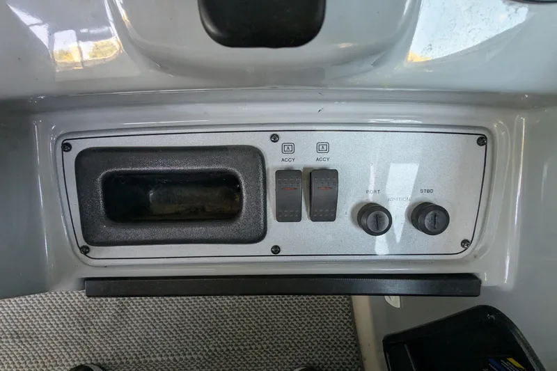 Slide: The Image of Control panel of a 2004 Maxum 3700 SY boat with switches and ignition keys. - 15