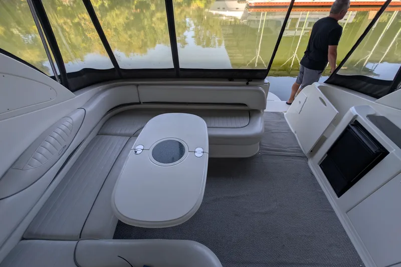 Slide: The Image of 2004 Maxum 3700 SY yacht interior with seating and table, overlooking water. - 21