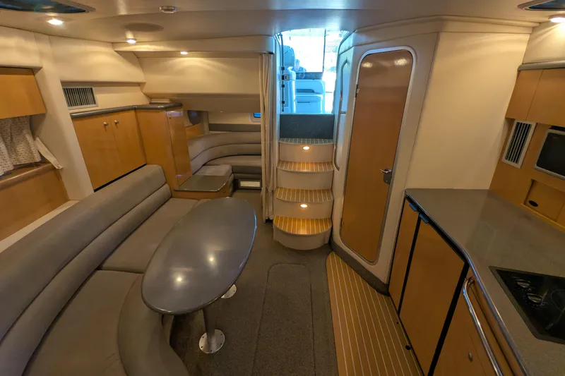 Slide: The Image of Luxurious interior of 2004 Maxum 3700 SY yacht with modern seating and kitchenette. - 22