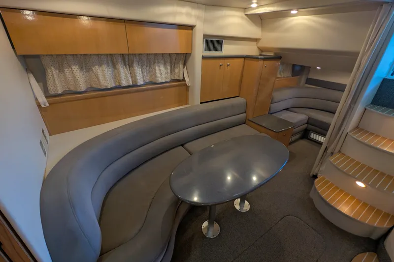 Slide: The Image of Interior of 2004 Maxum 3700 SY yacht with curved seating and table. - 23