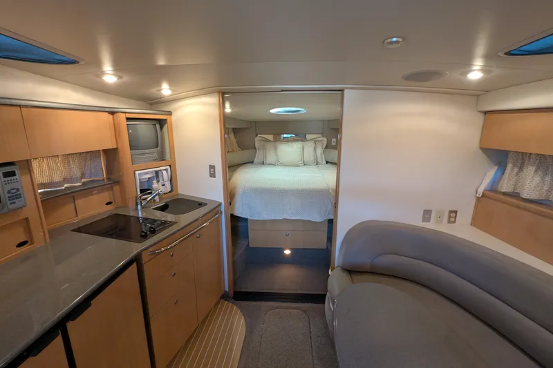 Slide: The Image of Luxurious interior of 2004 Maxum 3700 SY yacht with cozy bedroom and modern kitchenette. - 25