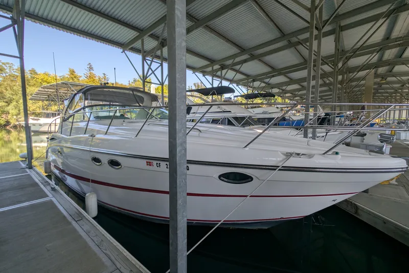 Slide: The Image of 2004 Maxum 3700 SY yacht docked in a covered marina. - 3
