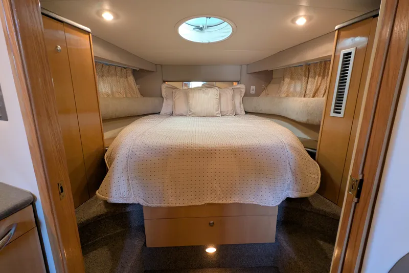 Slide: The Image of Luxurious bedroom interior of 2004 Maxum 3700 SY yacht with cozy bedding and ambient lighting. - 31