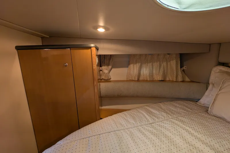 Slide: The Image of Cozy cabin interior of 2004 Maxum 3700 SY yacht with bed and wooden cabinet. - 32