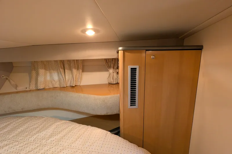 Slide: The Image of Interior cabin of 2004 Maxum 3700 SY yacht with wooden cabinetry and cozy bedding. - 33