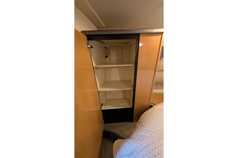 Slide: The Image of Open cabinet with shelves inside a 2004 Maxum 3700 SY boat interior. - 35