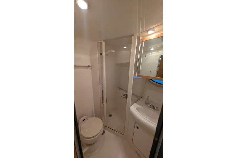 Slide: The Image of Bathroom interior of 2004 Maxum 3700 SY yacht with shower, toilet, and sink. - 36