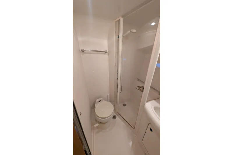 Slide: The Image of 2004 Maxum 3700 SY yacht bathroom with shower, toilet, and sink. - 38