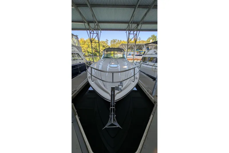 Slide: The Image of 2004 Maxum 3700 SY yacht docked under a covered marina. - 5