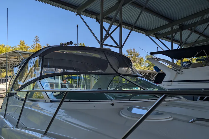 Slide: The Image of 2004 Maxum 3700 SY yacht docked under a metal canopy. - 6