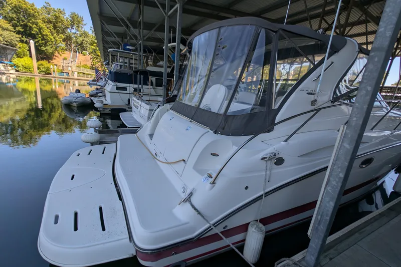 Slide: The Image of 2004 Maxum 3700 SY yacht docked in a marina under a covered structure. - 7