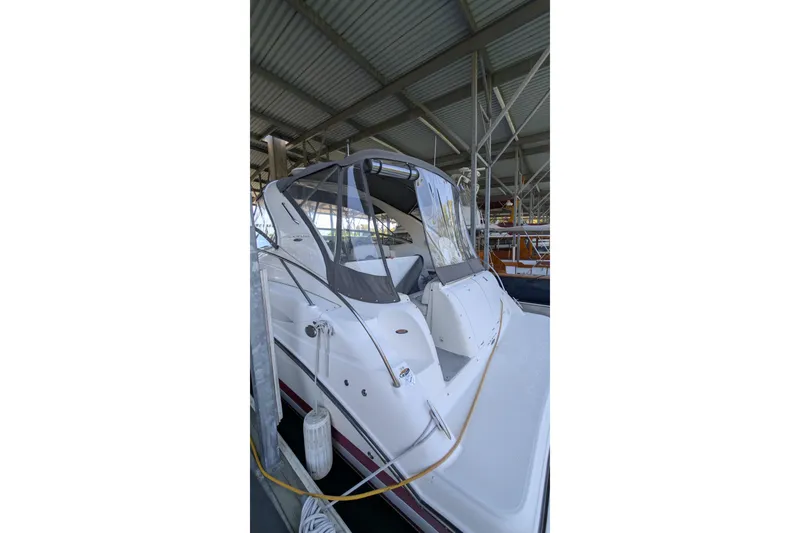Slide: The Image of 2004 Maxum 3700 SY yacht docked in a covered marina. - 9