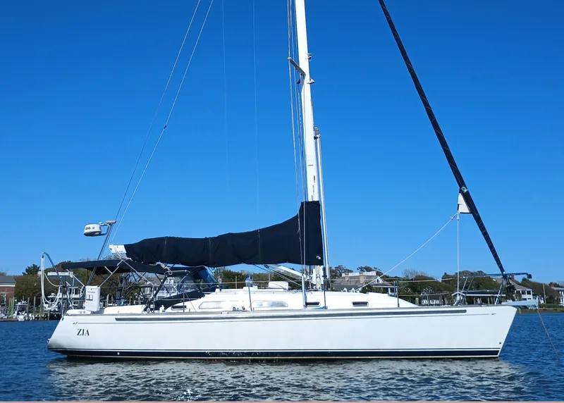 The Image of 2004 Sabre 386 sailboat on calm water under clear blue sky. - 0